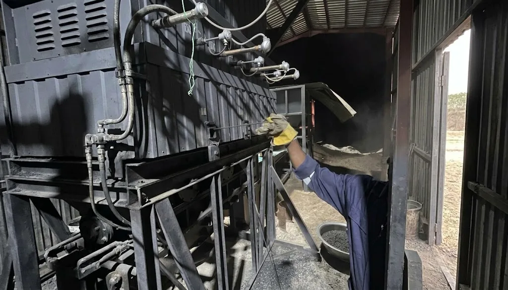 A team member works inside the production line, checking equipment and material.